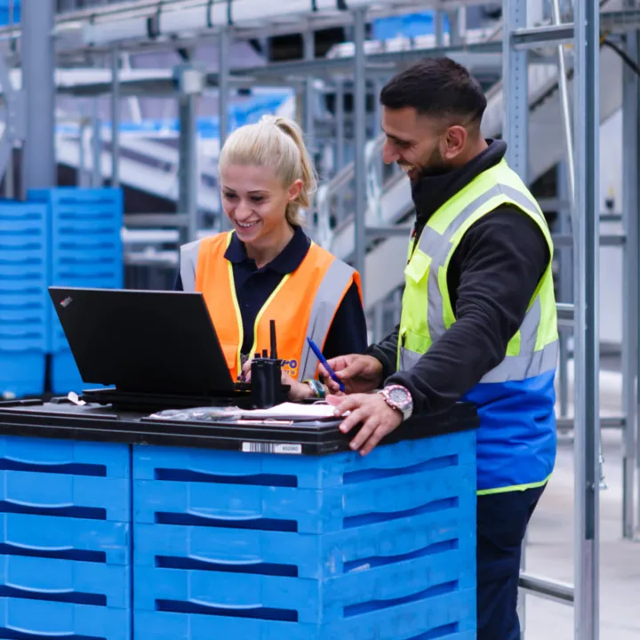 Man and women working in LKQ distribution center